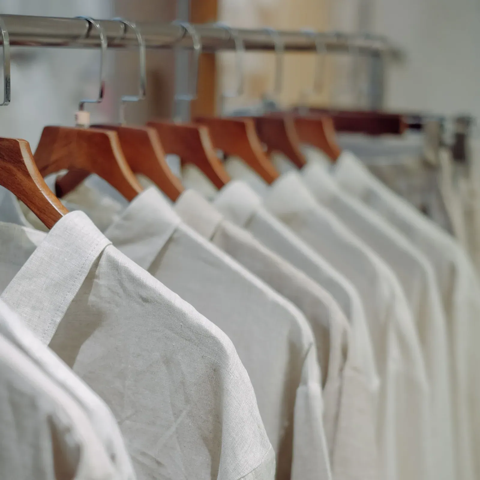 White shirts on wooden hangers