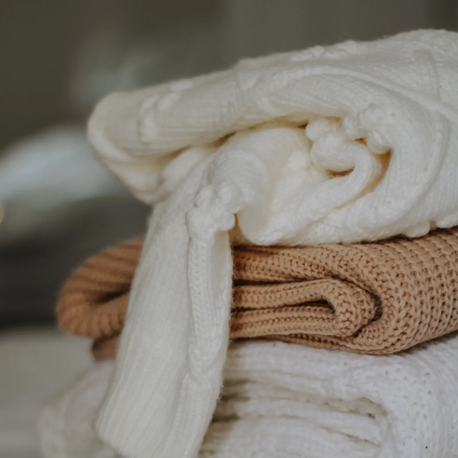 Folded knitwear in cream, tan and oatmeal