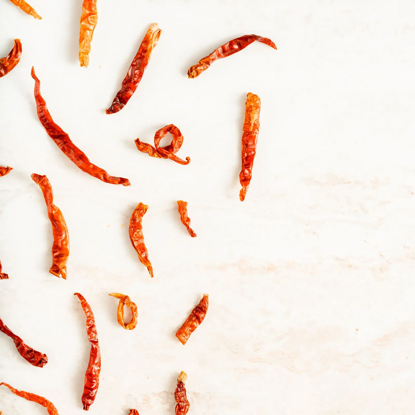 Dried red chillies scattered on marble