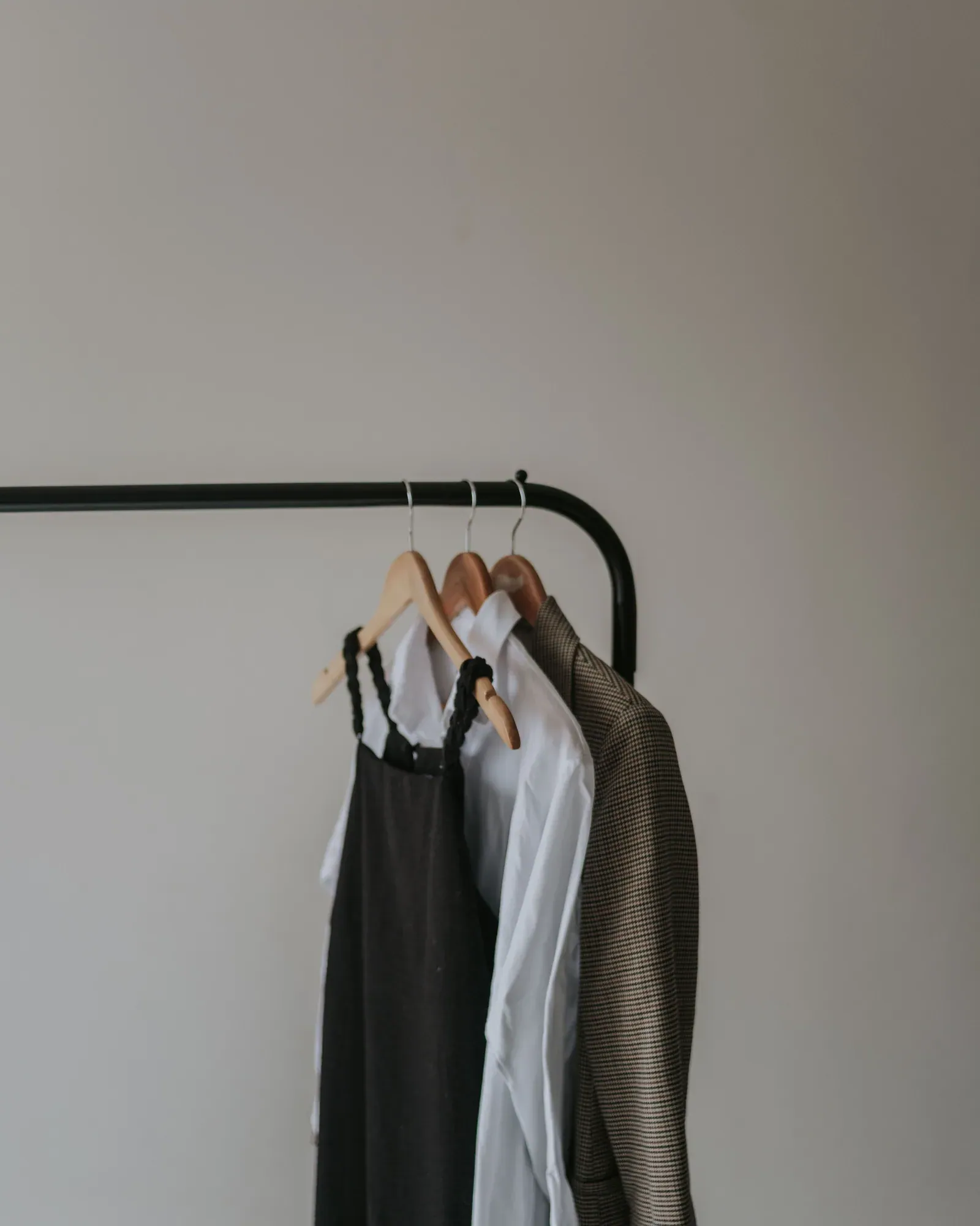 Pinafore dress, white shirt and grey blazer on wooden hangers