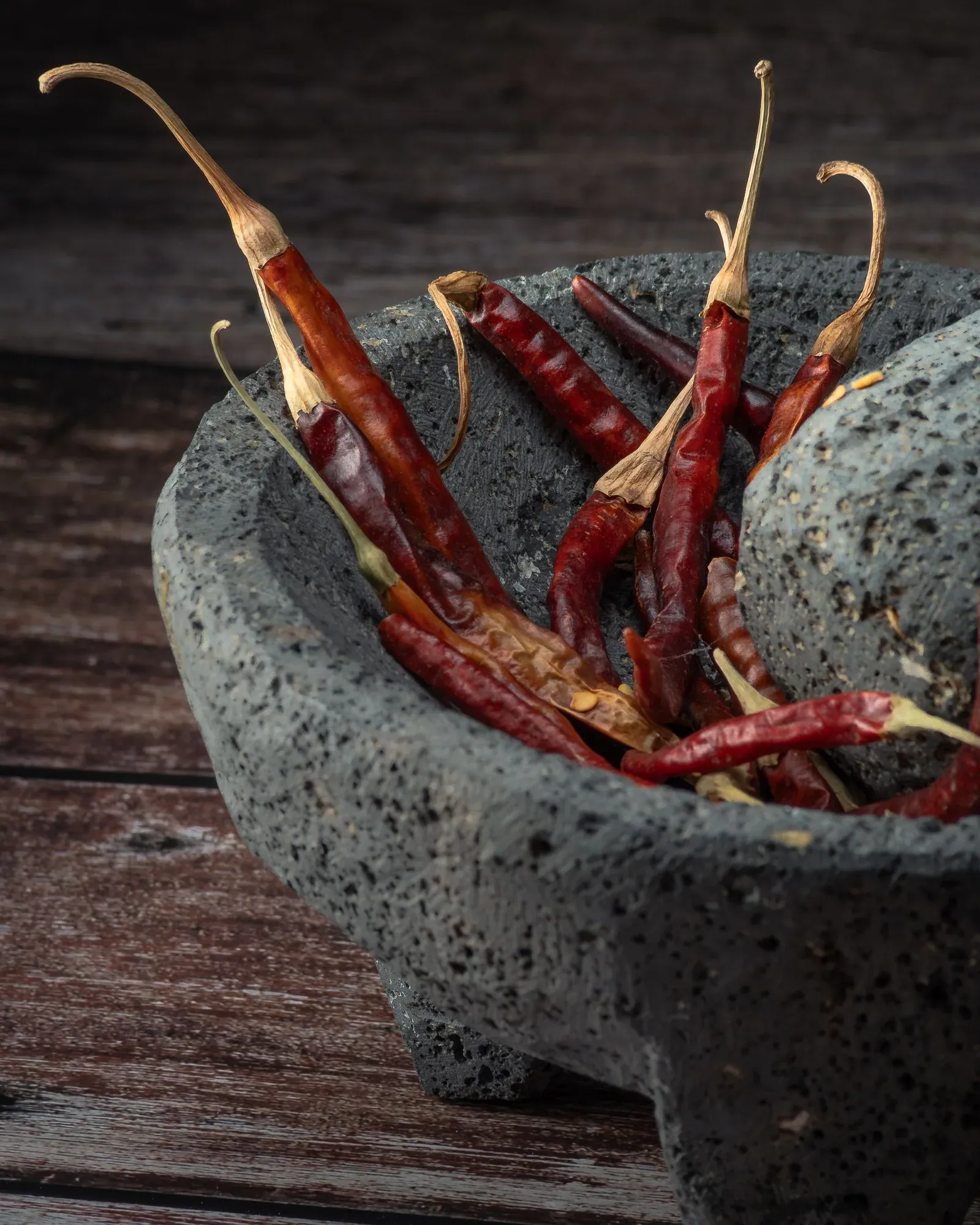 Dried red chillies in a stone mortar